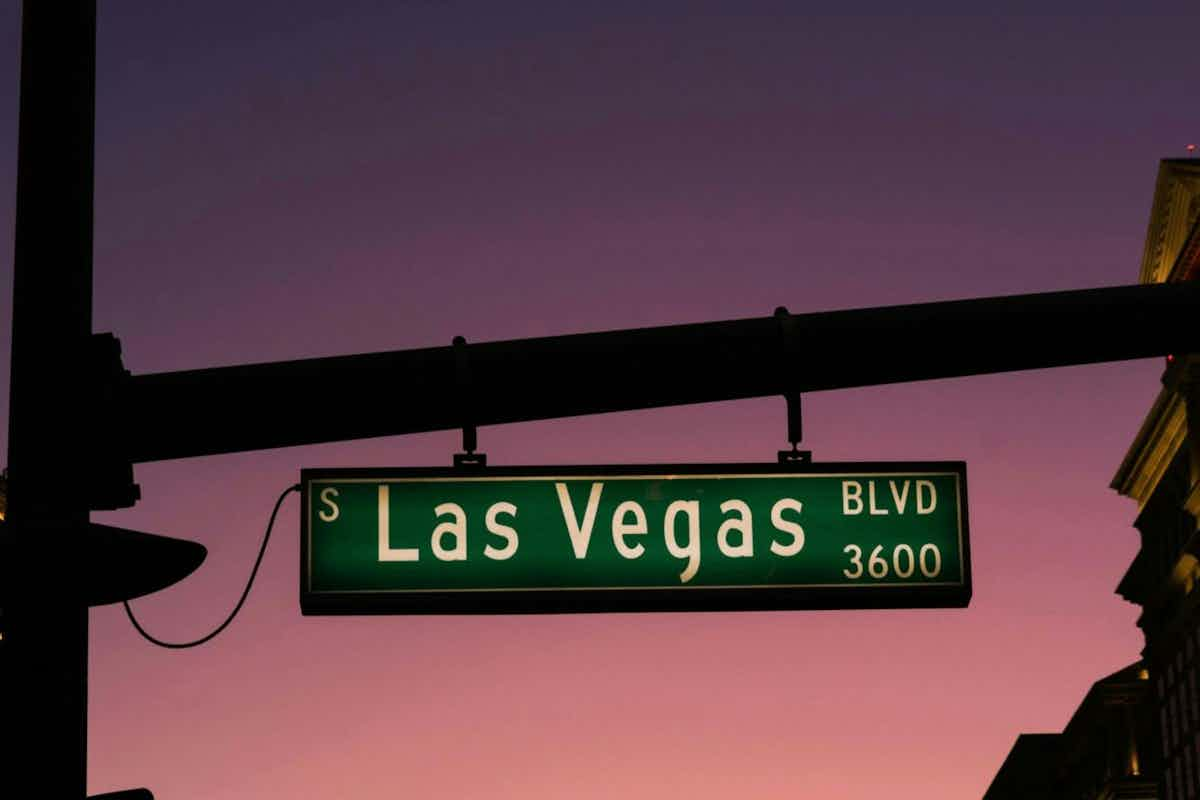 las vegas sign with a sunset in the background